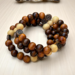this handmade bracelet is made of 10mm wood beads and is on memory wire, so its like a wrap bracelet, made it with a metal butterfly charm.
